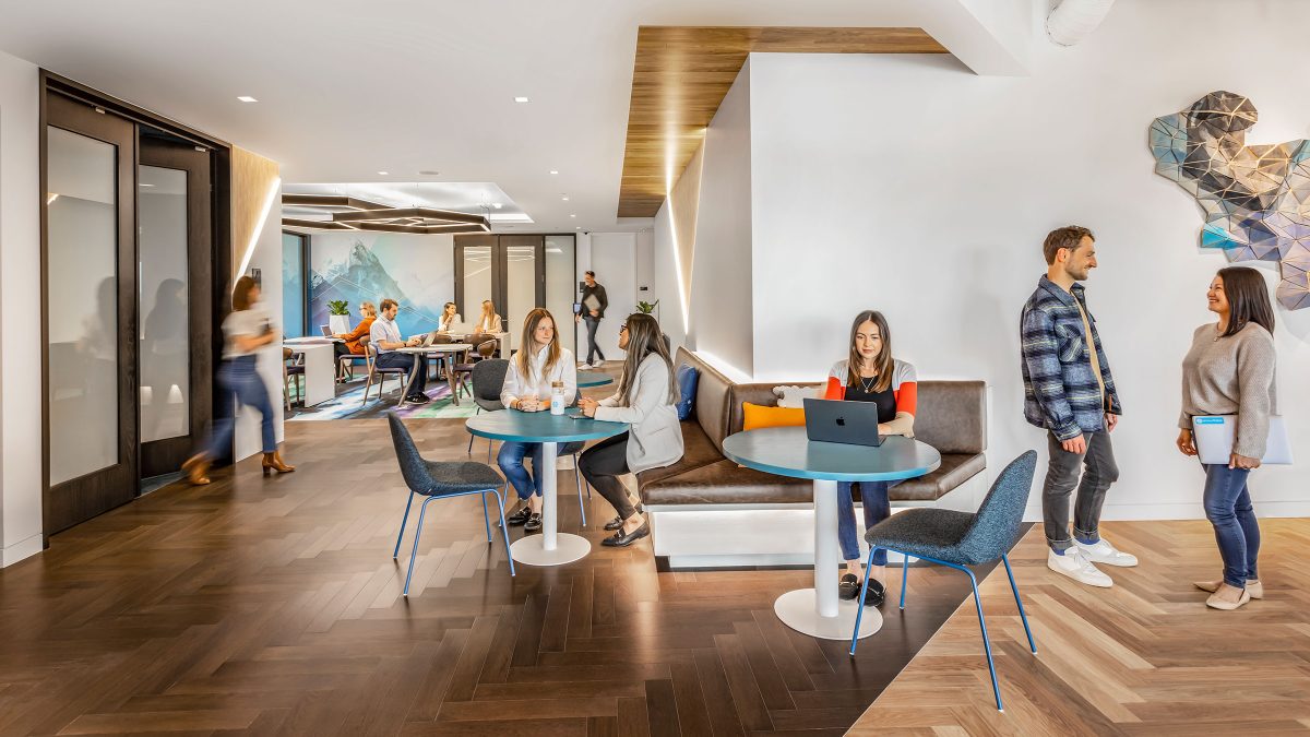 Circulation space connecting the meeting rooms supports break-out interaction and opportunities to immerse in the company through custom artwork, technology displays and branded graphics.